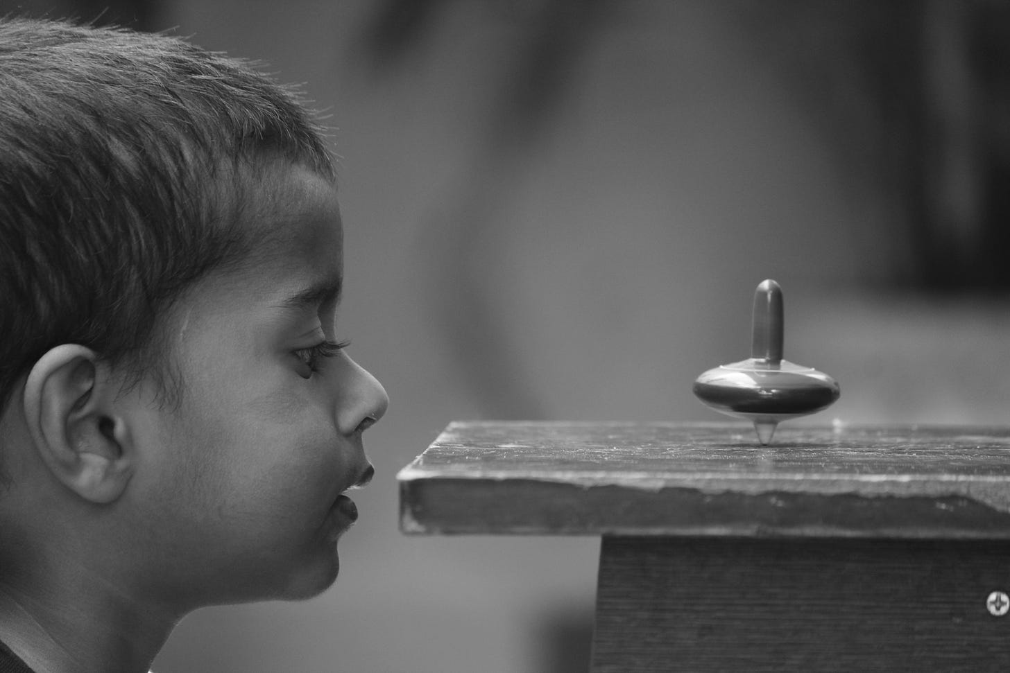 Photo of boy watching a spinning top