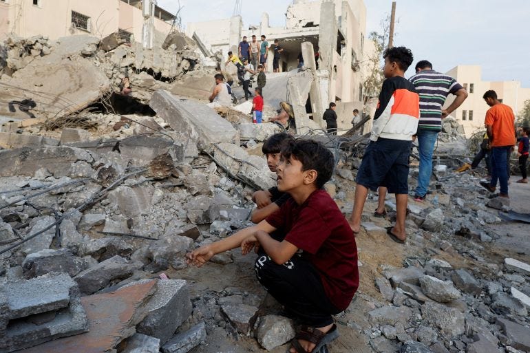 Palestinian children sit next destroyed building Palestinian children sit next destroyed building