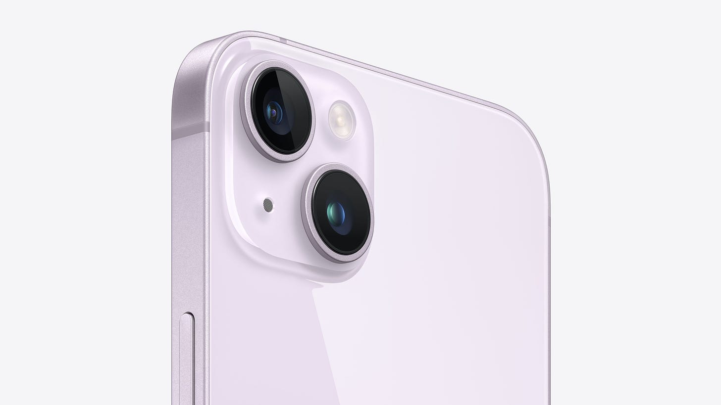 Angled close-up view of the dual-camera system on iPhone 14 Plus in purple.