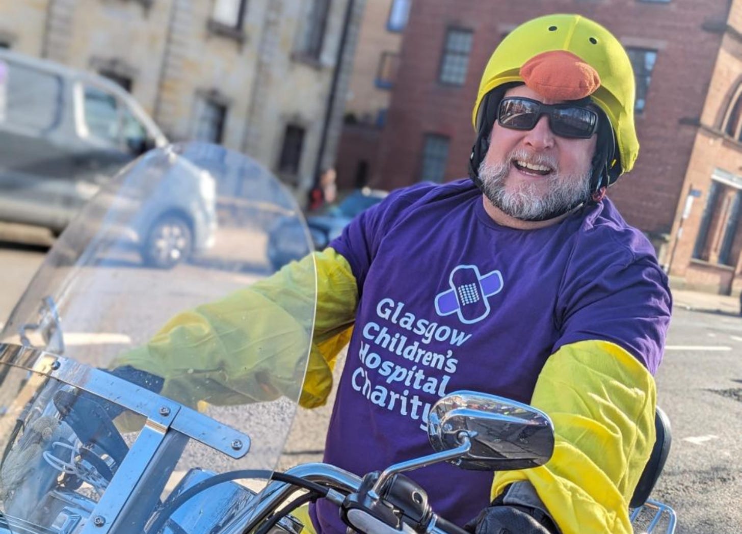 man on motorcycle wearing chicken costume