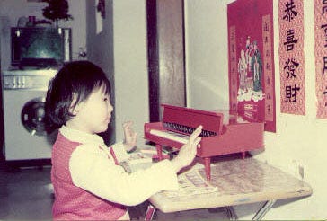 Louia playing with her toy piano at 4.