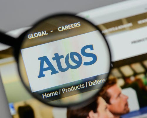 A photo of a looking glass focusing on the Atos logo.