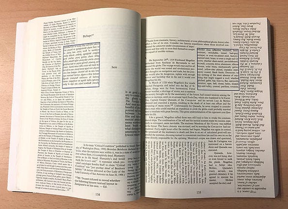 Open book on wooden surface with pages filled with dense black text, rotated text blocks highlighted by blue borders, pages numbered 134–135.