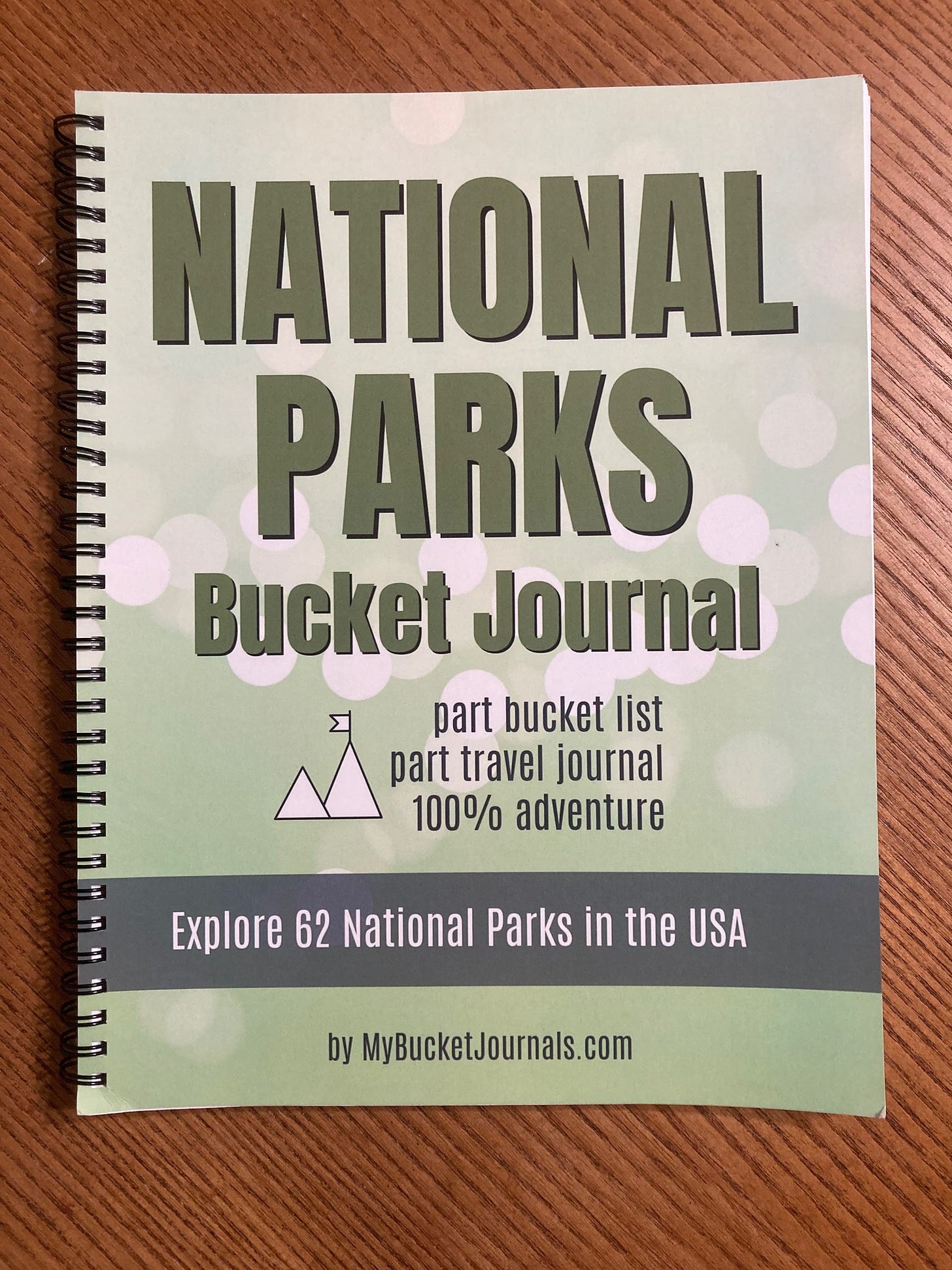 May be an image of ‎text that says '‎NATIONAL PARKS Bucket Journal part bucket list part travel journal 100% adventure Explore 62 National Parks in the USA _ور byMyBucketJournals.com‎'‎