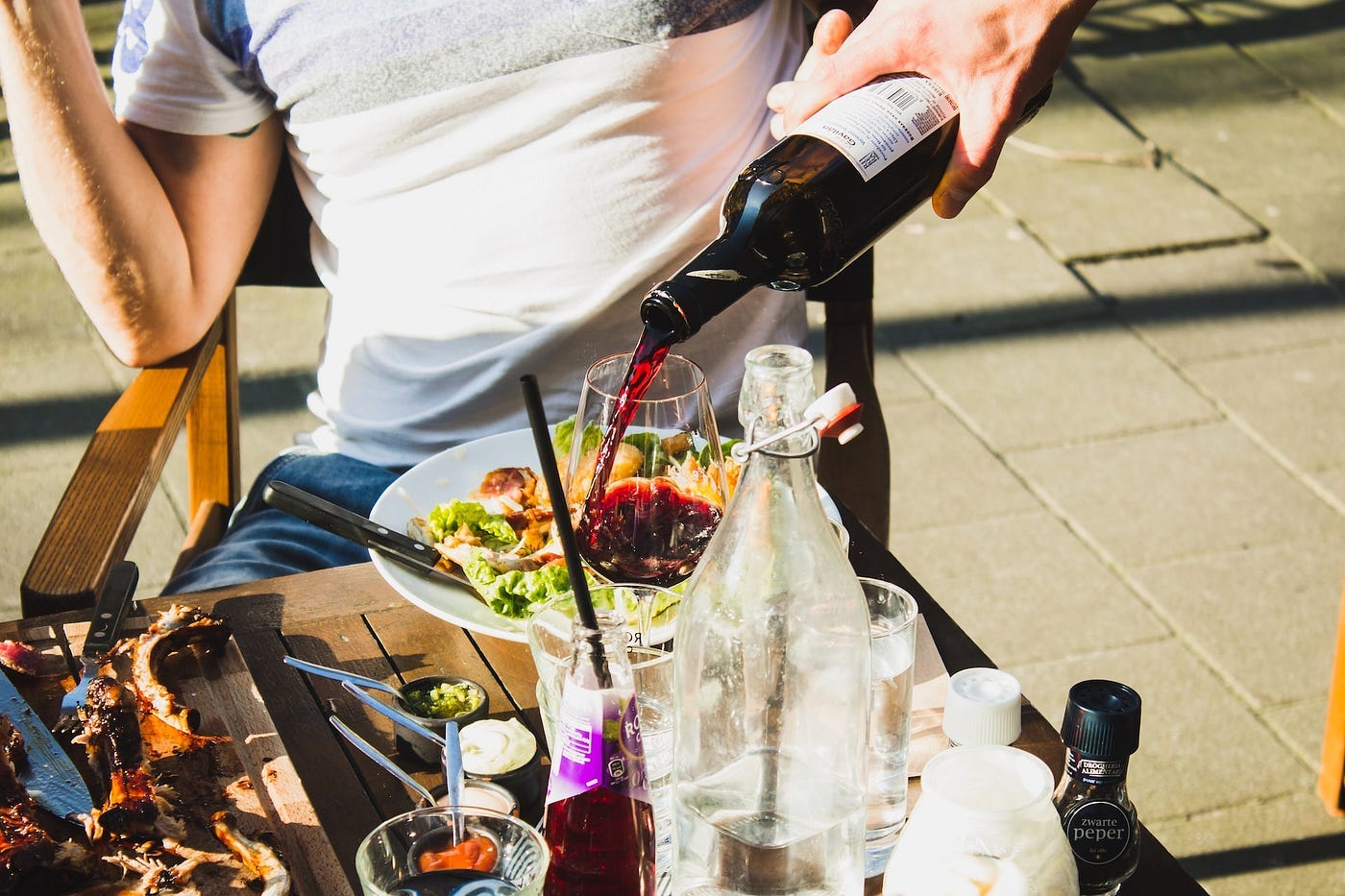 A sommelier pouring a glass of wine for a restaurant guest