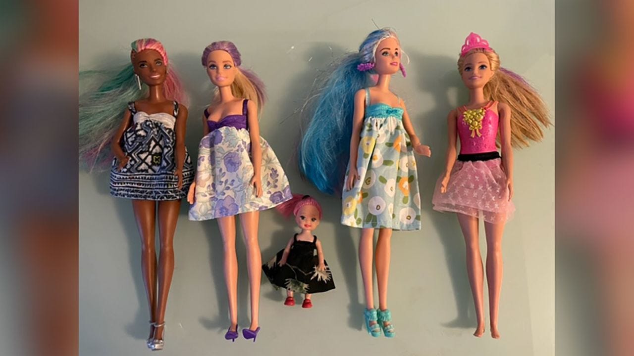 Barbies wear outfits Barbara Lakin sewed as gifts for migrant children.