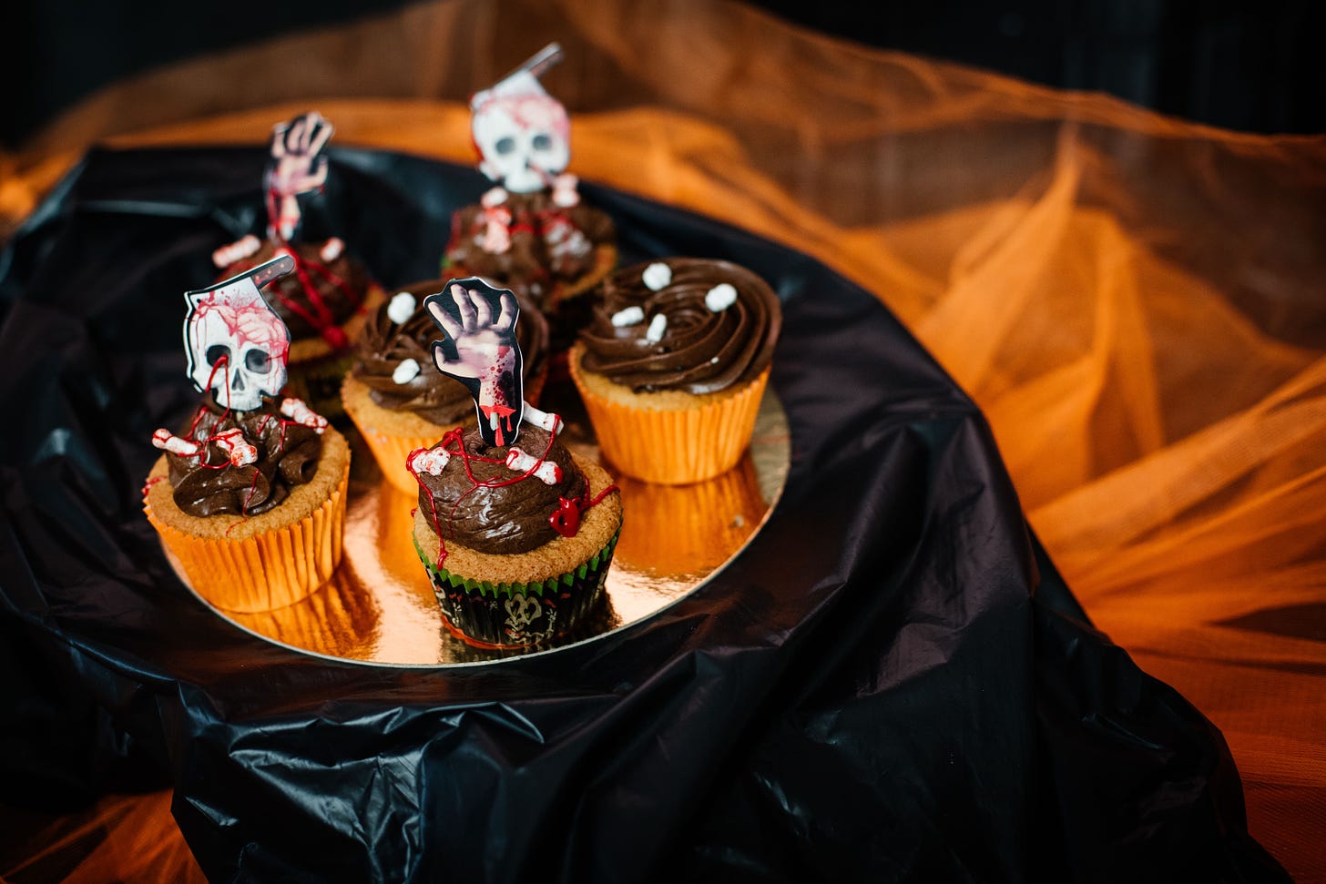 Pumpkin muffins with chocolate frosting dressed up for Halloween