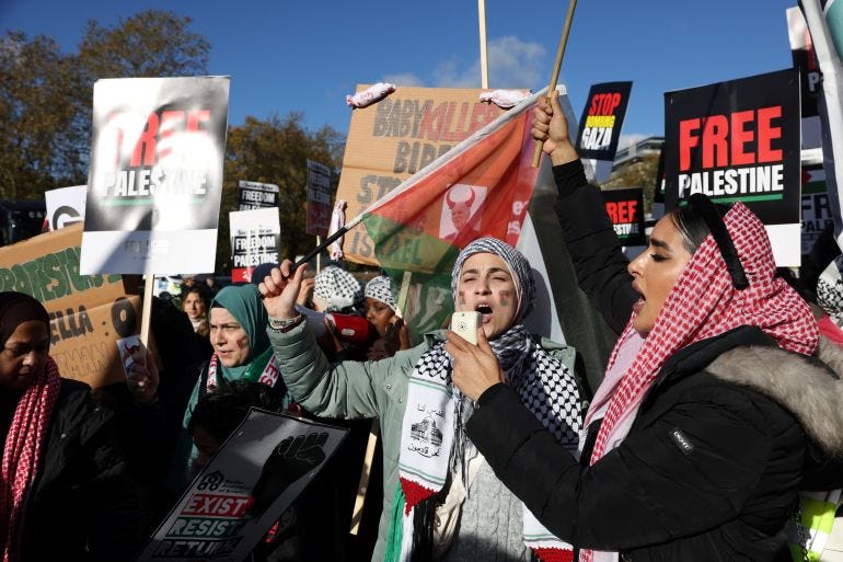 Demonstrators gather to attend a protest in solidarity with Palestinians in Gaza in London