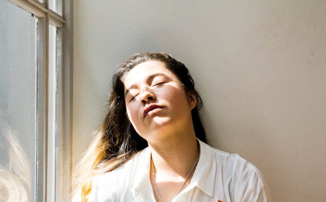 woman standing near window during daytime