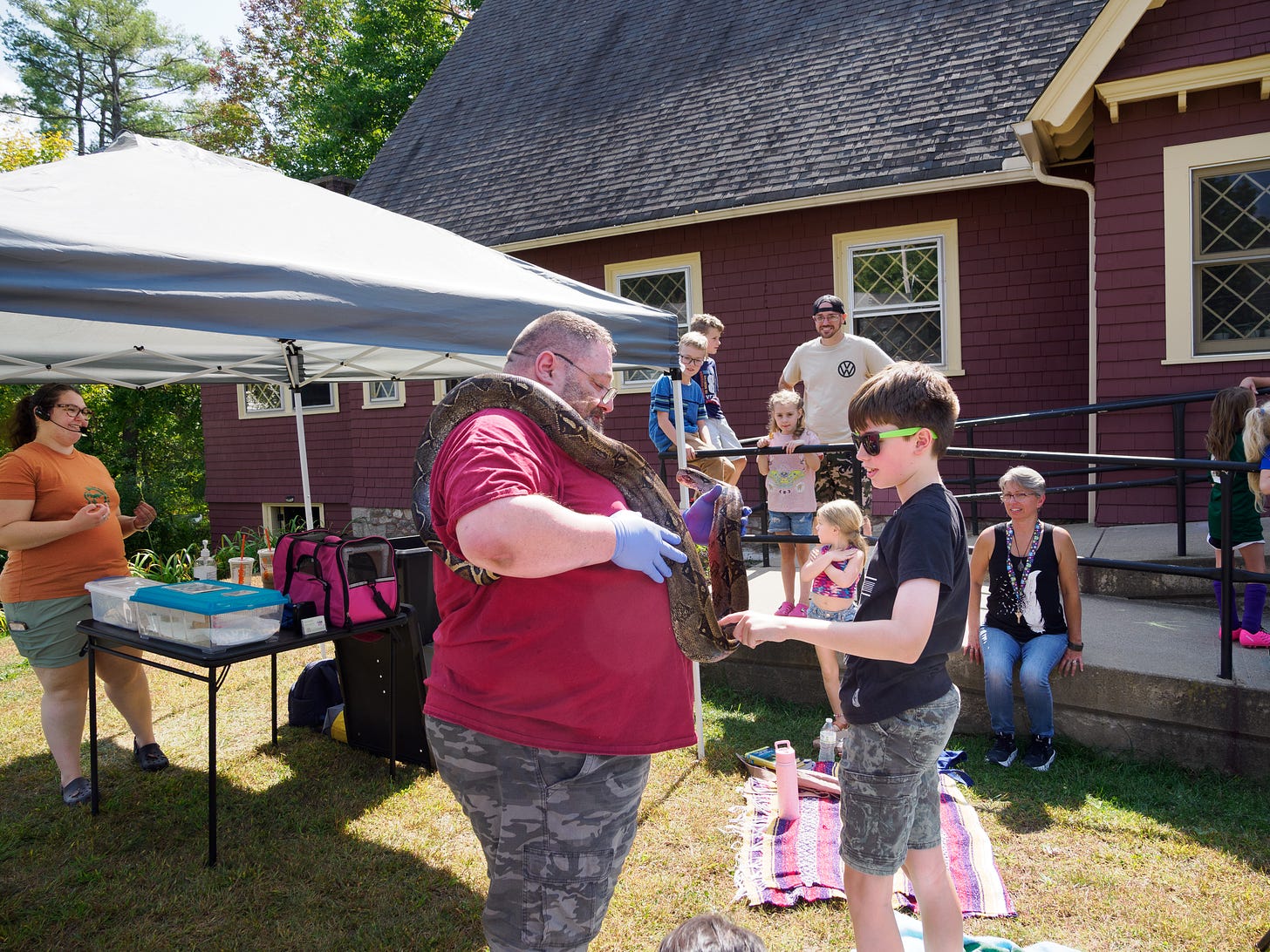 Zachary Decoteau shows a phython to children