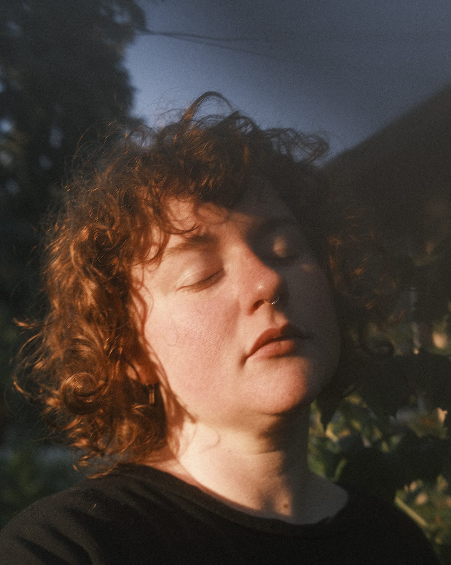 Me with my eyes closed, head tilted toward the morning sun