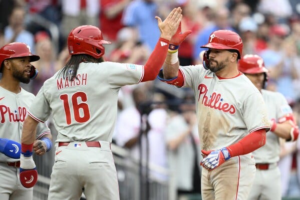 Philadelphia Phillies' Kyle Schwarber, right, celebrates his three-run home run with Brandon Marsh (16) during the sixth inning of a baseball game against the Washington Nationals, Saturday, March 29, 2025, in Washington. (AP Photo/Nick Wass) Philadelphia Phillies' Kyle Schwarber, right, celebrates his three-run home run with Brandon Marsh (16) during the sixth inning of a baseball game against the Washington Nationals, Saturday, March 29, 2025, in Washington. (AP Photo/Nick Wass)