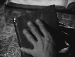 GIF of the opening of a book with the title "Satan