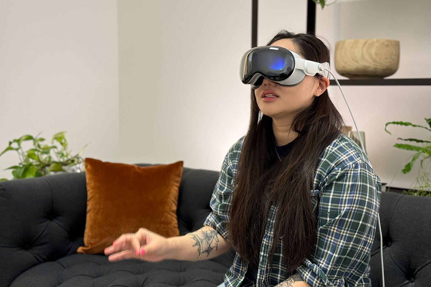 Woman wearing Vision Pro while pinching fingers