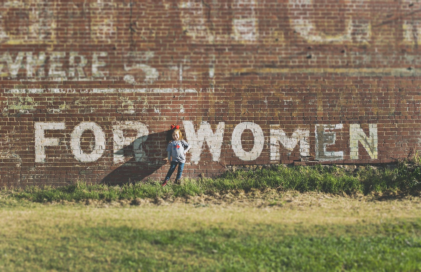 It was election day, 2016. Every single day on the way to school in this really old neighborhood of Clarksburg, we passed this faded ad painted on this brick building, and I knew that this day was going to be the day to snap a photo. That’s my daughter. The day ended much different than it started, but this moment was perfect.