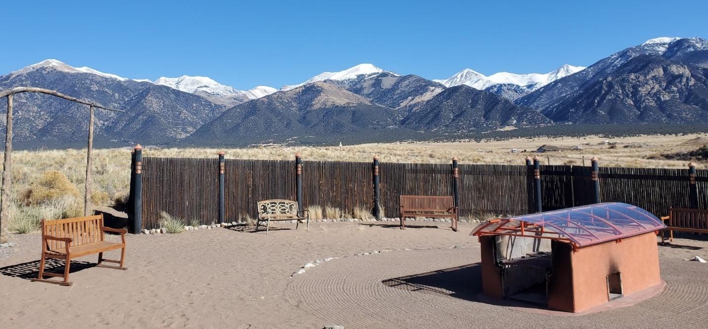 A fence with mountains in the background

Description automatically generated