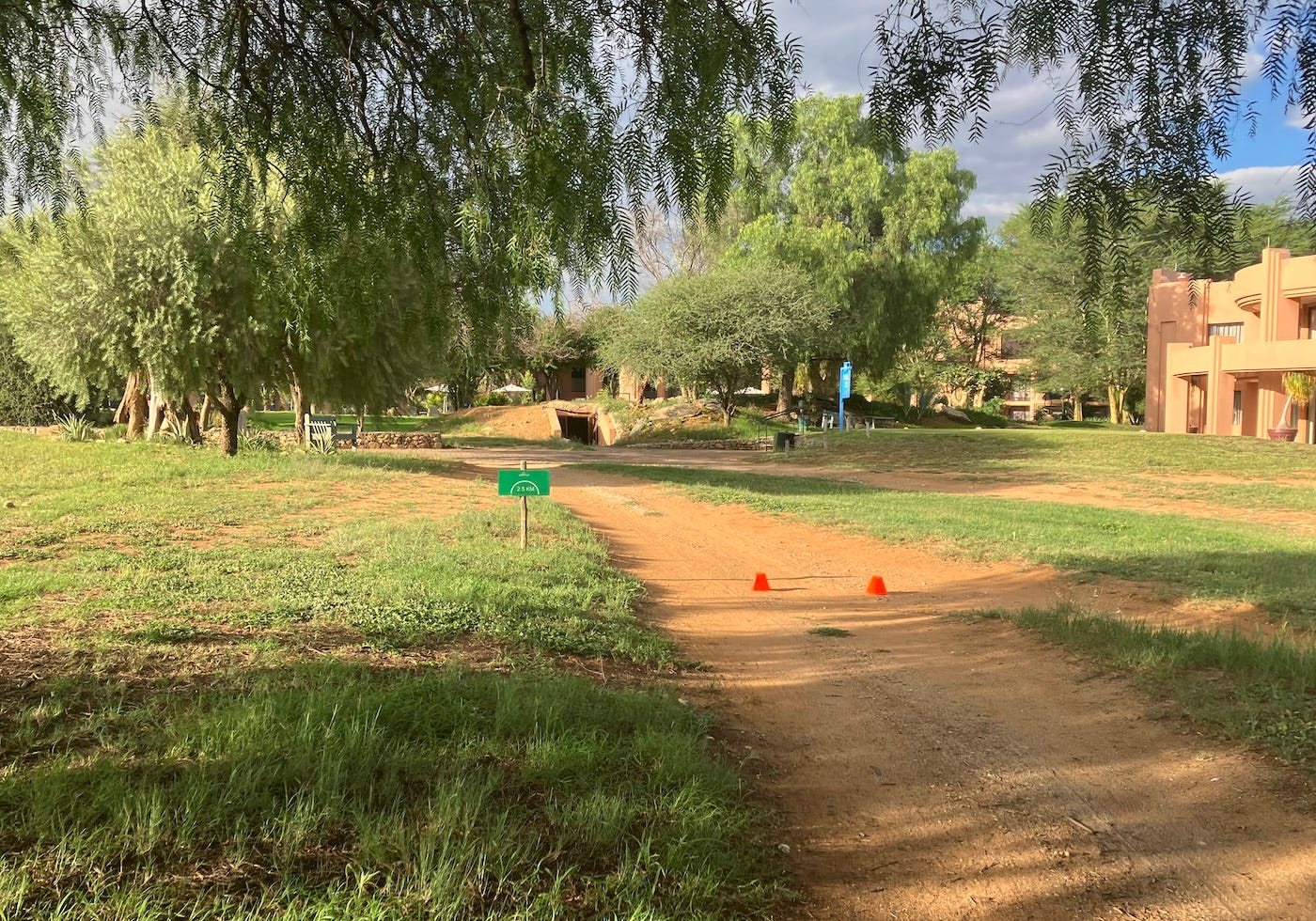 Two cones and a sign mark the turnaround point on the path