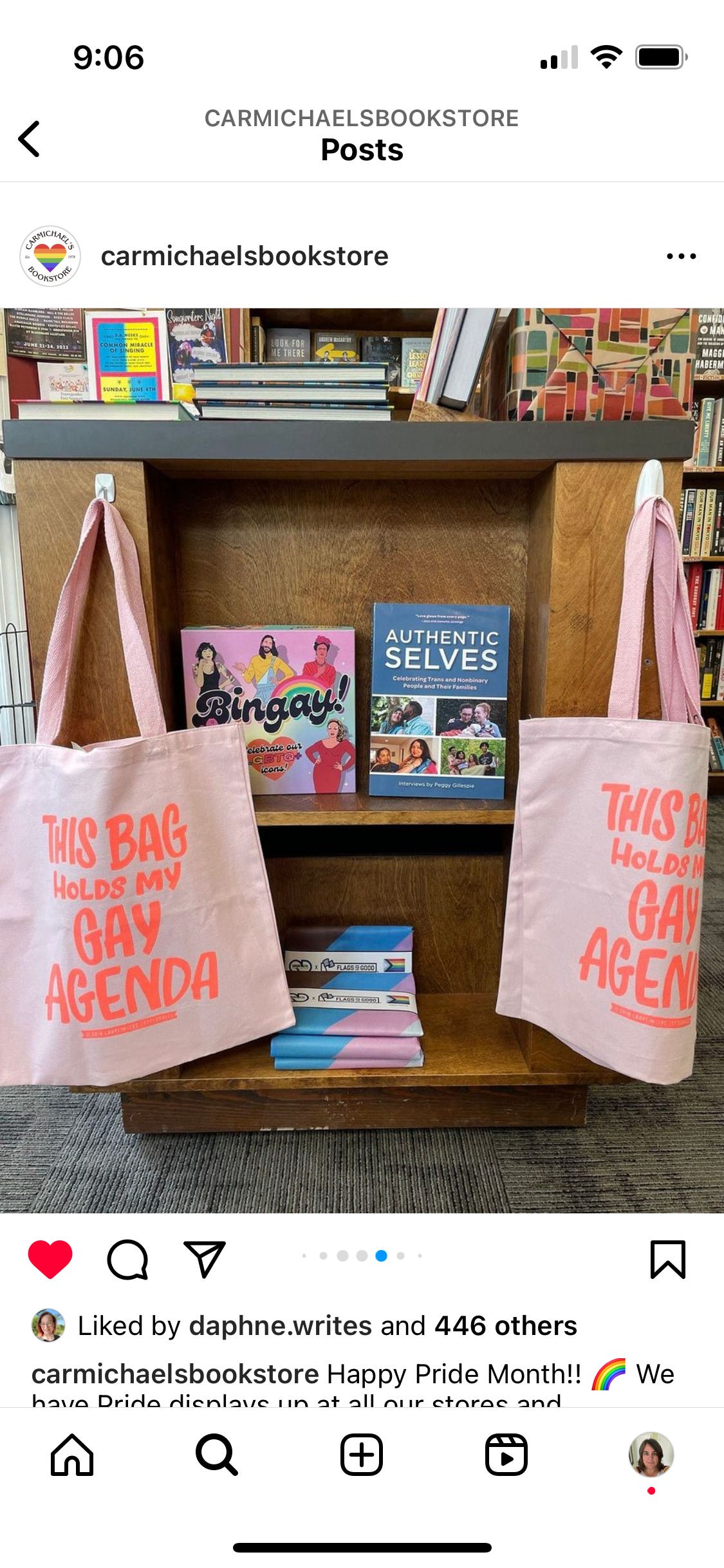 Pride book display with pink bags that say, "This bag holds my gay agenda."