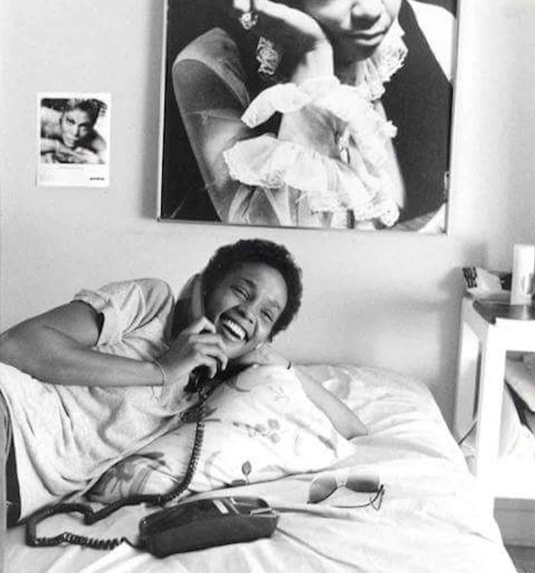 Teenage Whitney Houston talking on the phone in her bedroom