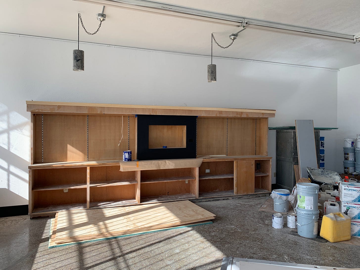 sun filled vacant retail space with construction materials strewn about