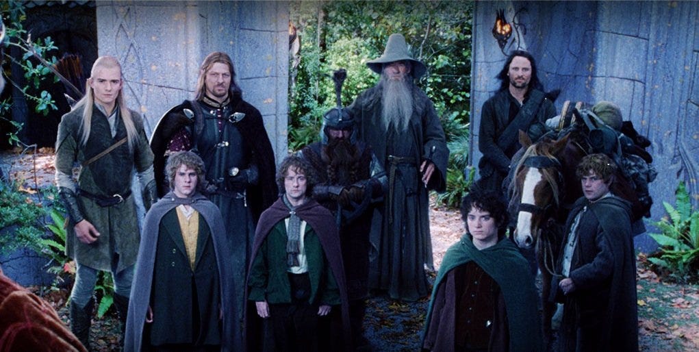 the Fellowship of the Ring stands in the courtyard in Rivendell