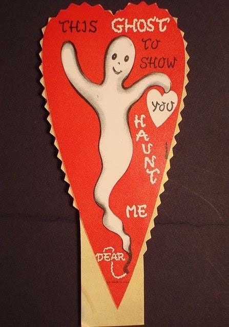 Long, skinny, super old-looking valentine in the shape of a heart. A happy-looking whispy ghost takes up most of the space. Text: This GHOST to show you haunt me, dear."