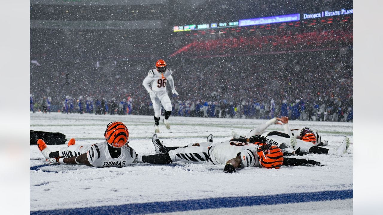 Bengals defense make snow angels in the endzone in celebration during the fourth quarter of the Bengals-Bills divisional game at Highmark Stadium on Sunday, January 22 2023.