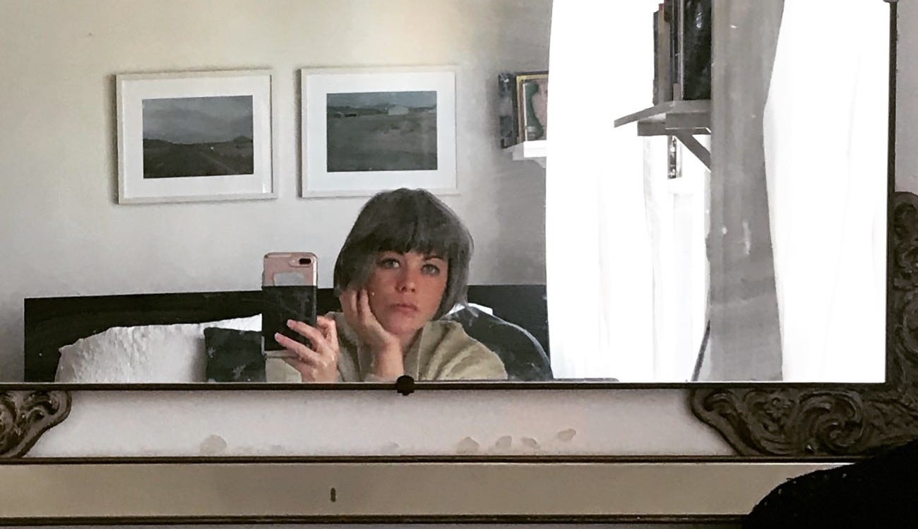 A photo of the author taking a photo of herself in the mirror.
