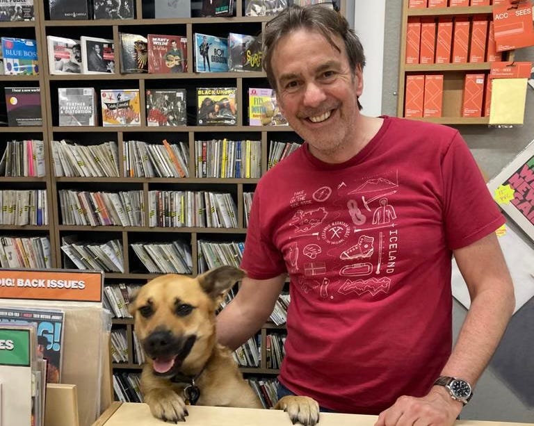 Nick and his dog Libby, behind the counter in Jumbo Records