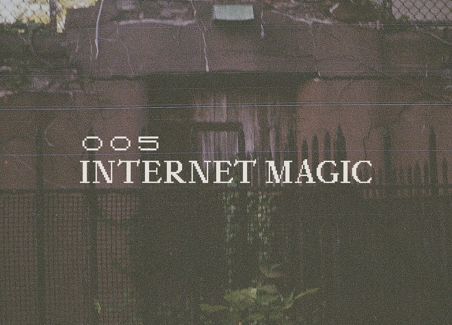 Overgrown iron gate in front of a brown building. Distorted film quality, reads "005 Internet Magic" in a pixelated serif font.