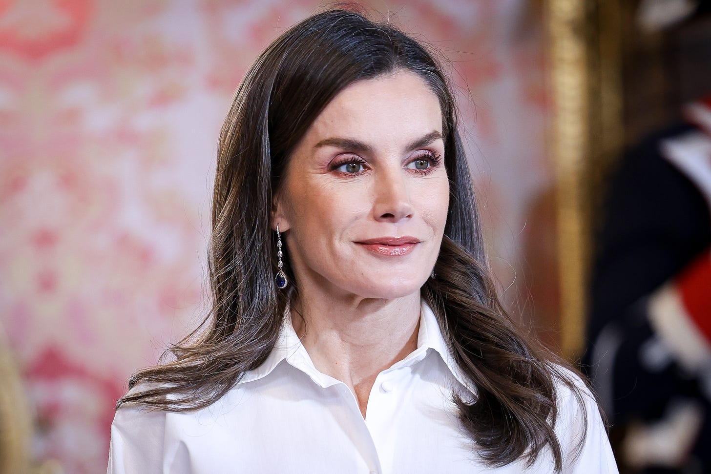 Queen Letizia smiling in white shirt