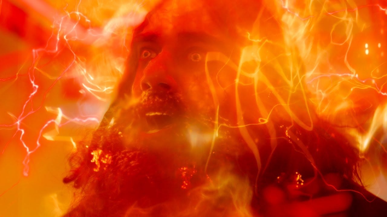 This image shows the Master (played by Sacha Dhawan) expressing glee as his forced regeneration of the Thirteenth Doctor begins in Doctor Who Series 13's ninth episode, "The Power of the Doctor." Waves of coruscating, amber regeneration energy envelop the Master's body. This image shows the Master (played by Sacha Dhawan) expressing glee as his forced regeneration of the Thirteenth Doctor begins in Doctor Who Series 13's ninth episode, "The Power of the Doctor." Waves of coruscating, amber regeneration energy envelop the Master's body.