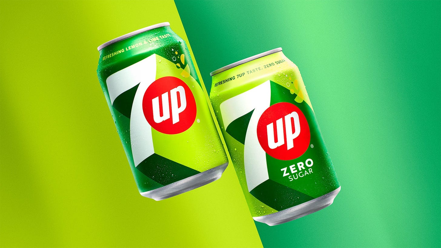 Image shows two cans of 7UP featuring its new green and lime packaging design