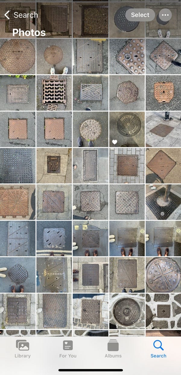 A screenshot of Becky's iPhone photo library, showing a grid of at least 50 different photographs of manholes.