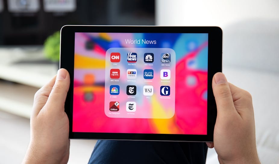 Electronic tablet showing global media apps. 