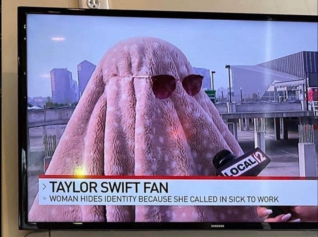 Swift fan hides face under pink blanket and sunglasses
