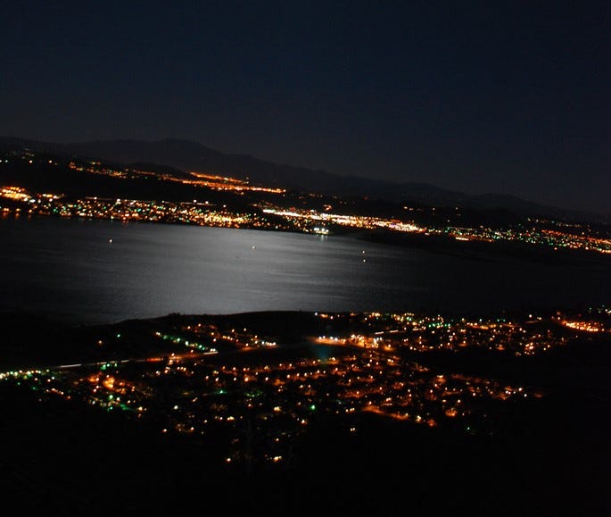 City of Lake Elsinore at night showing the lake and the city lights glowing
