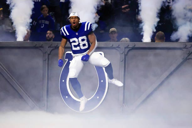 Jonathan Taylor of the Indianapolis Colts jumps in the air while taking the field prior to a game against the New Orleans Saints at Lucas Oil Stadium...