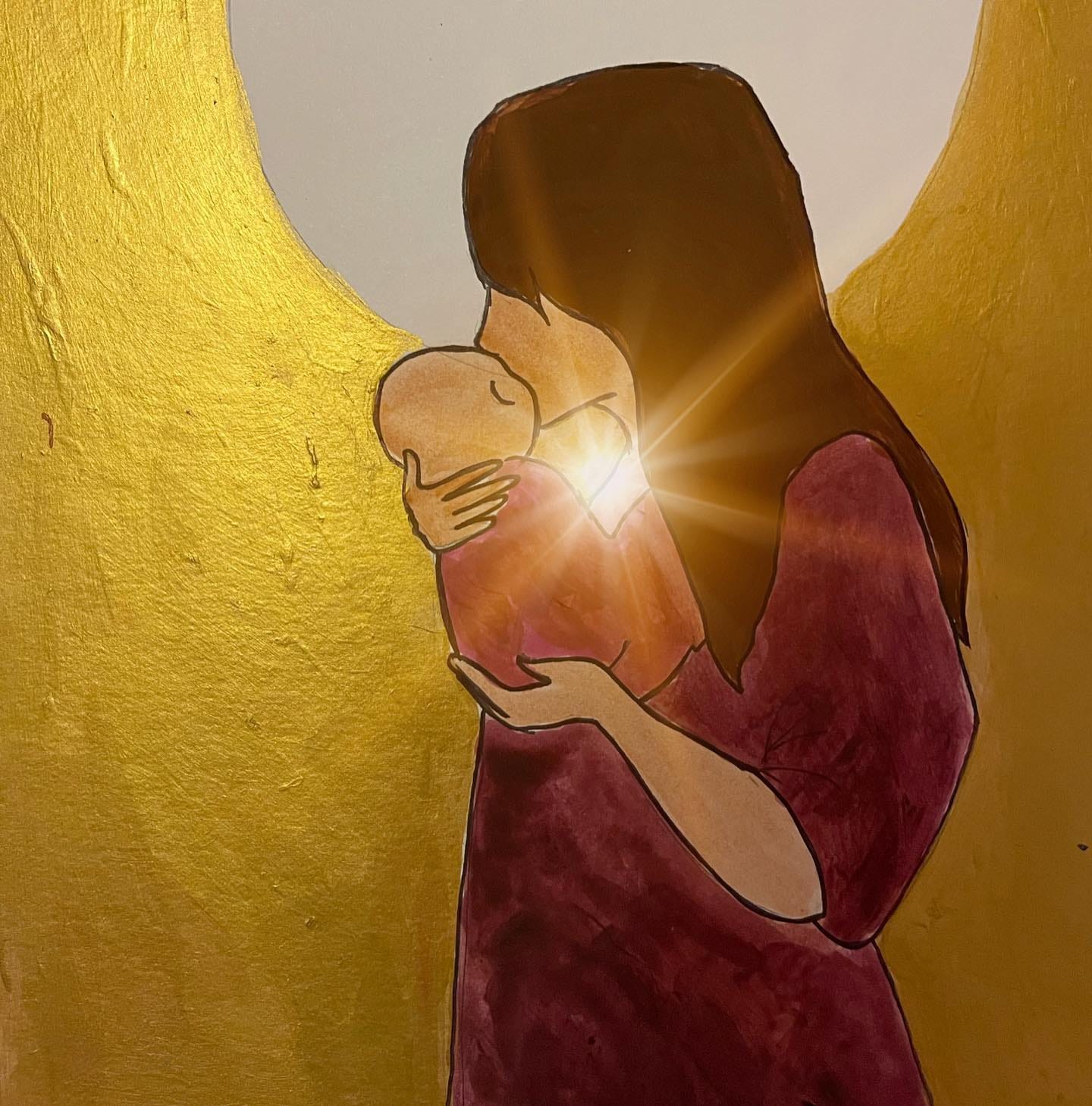 mother kissing newborn with glowing light behind them