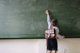 A kid cleaning the blackboard Stock Photo | Adobe Stock