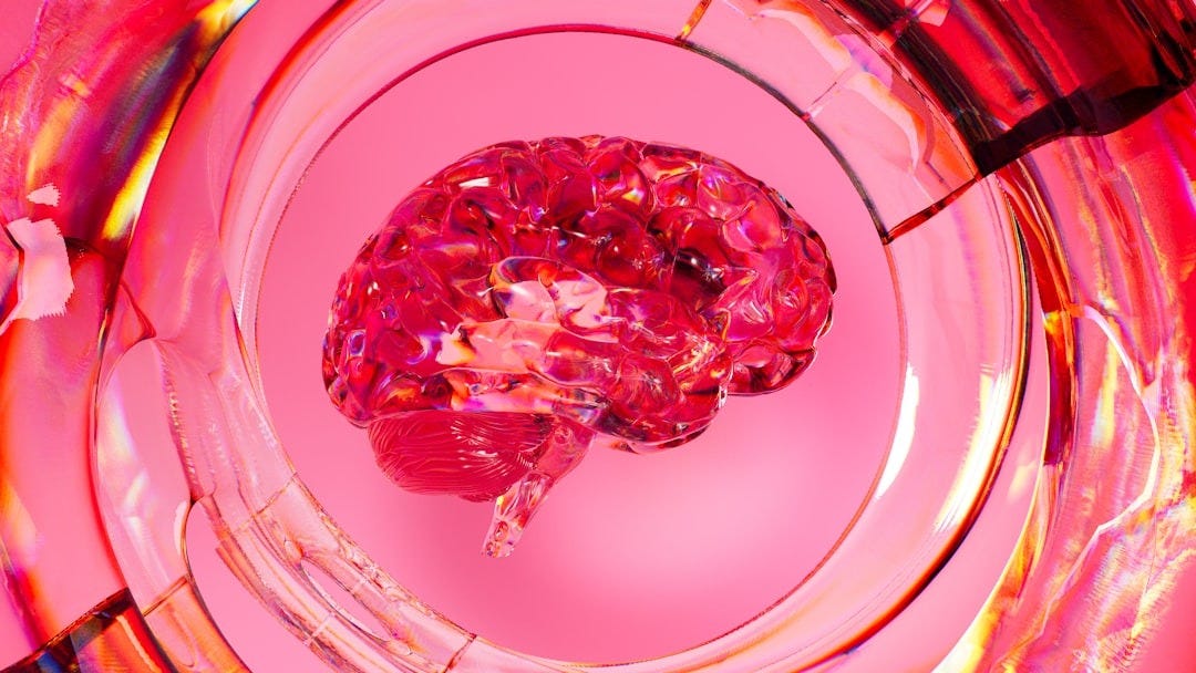 A close up of a glass with a pink substance in it