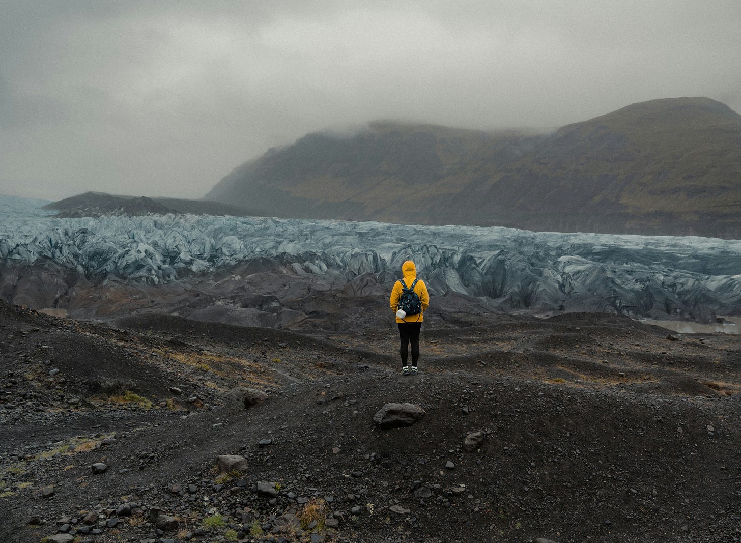 Person looking out on a misty landscape representing an unknown future