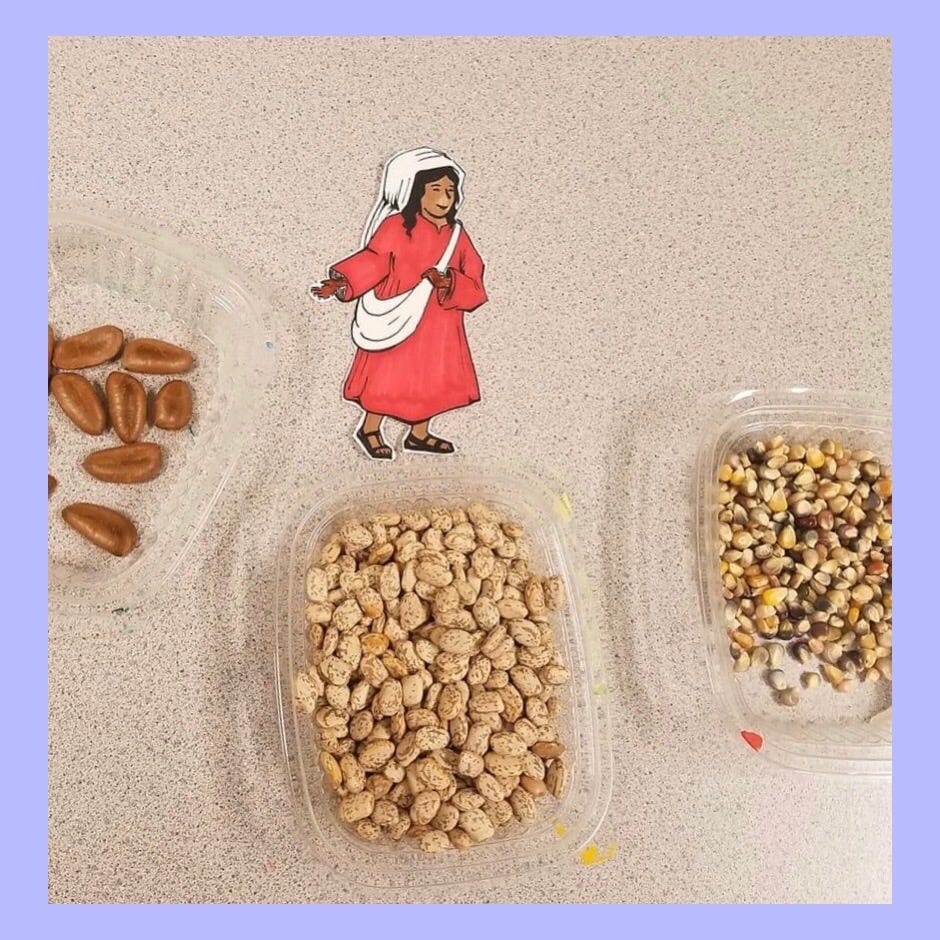 A photo of three clear containers holding different types of seeds and a small illustrated figure of a female sower.