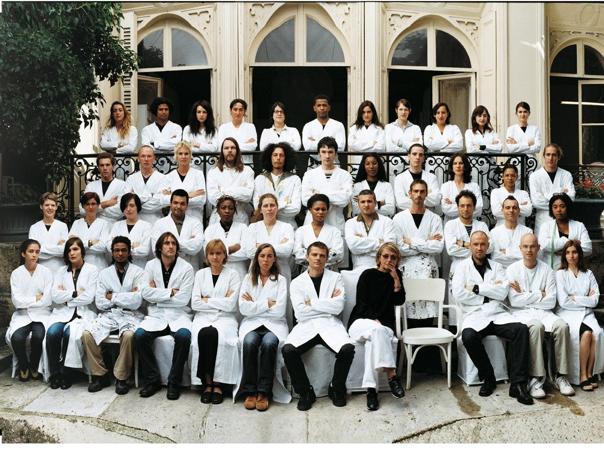 The Maison Martin Margiela team in 2008 with an empty seat for Martin Margiela
