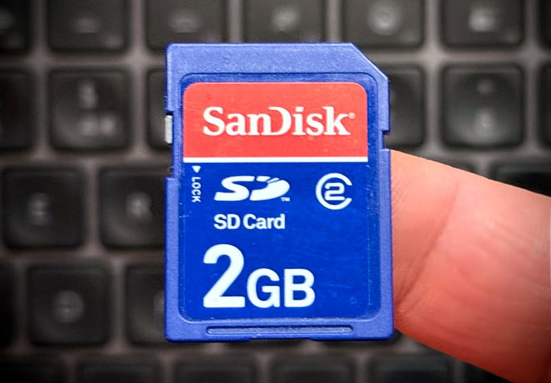 A 2GB sd card resting on a finger