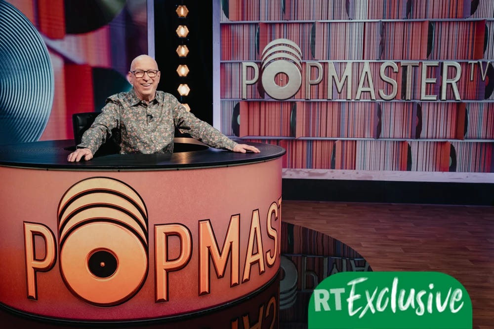 Photo of Ken Bruce in presenter's seat of the television version of the show