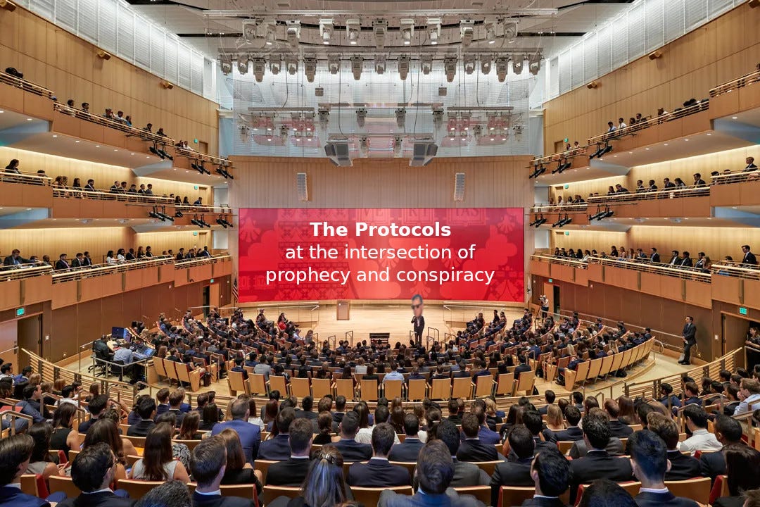 Auditorium at the Harvard Business School with a large sign "The Protocols at the intersection of prophecy and conspiracy Auditorium at the Harvard Business School with a large sign "The Protocols at the intersection of prophecy and conspiracy