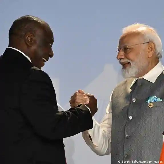 South African President Cyril Ramaphosa, left, and Indian Prime Minister Narendra Modi lock hands during the 15th BRICS Summit at the Sandton Convention Centre in Johannesburg, South Africa.