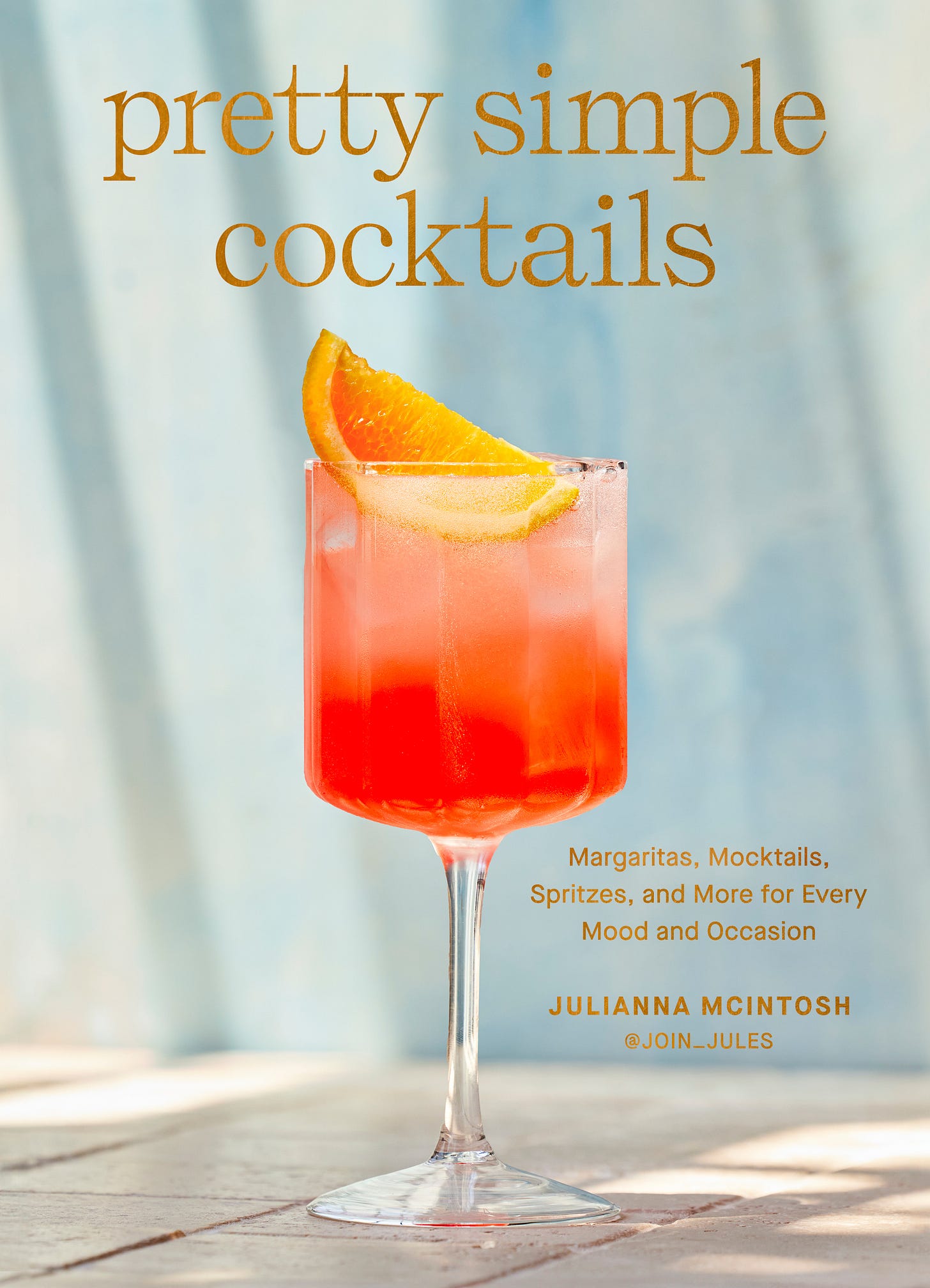 cover of pretty simple cocktails book with pink drink and light blue background