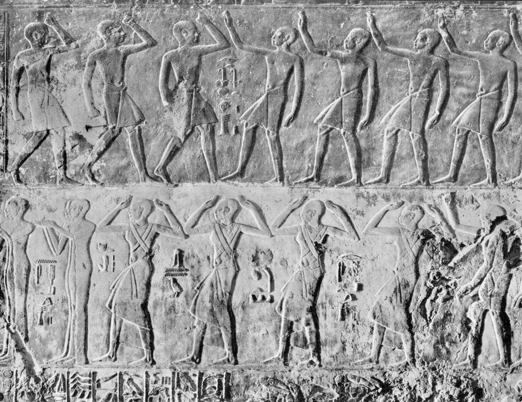 A stone carving of people dancing
Description automatically generated A stone carving of people dancing
Description automatically generated